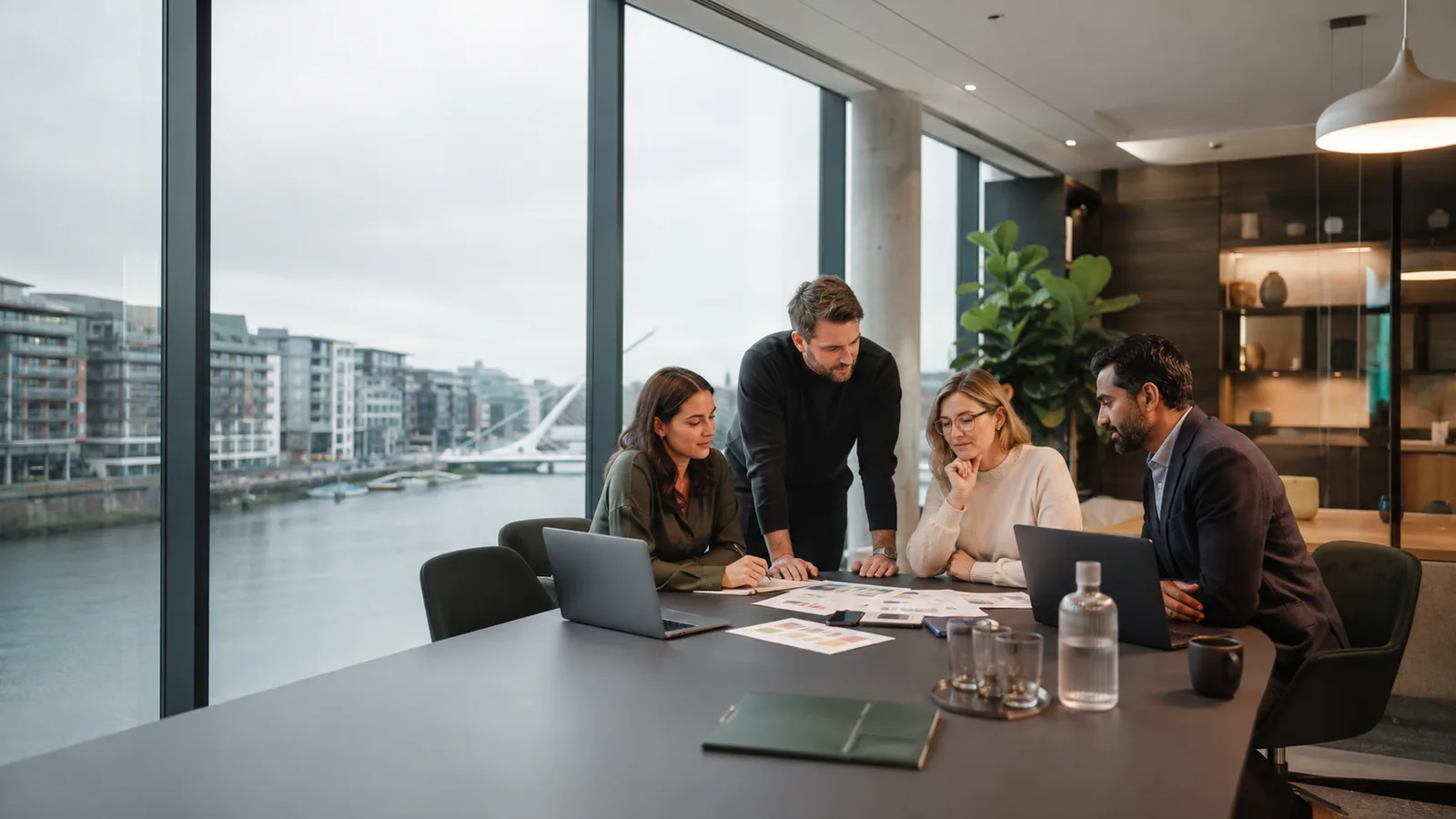 Business team reviewing customer acquisition strategy in a Dublin Docklands office